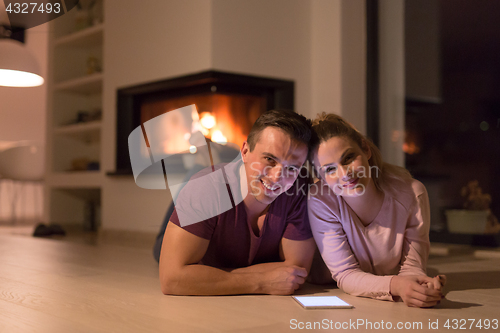 Image of Young Couple using digital tablet on cold winter night