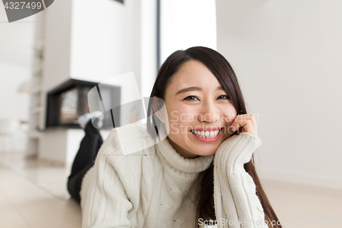 Image of young Asian woman using laptop on the floor