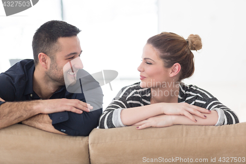 Image of Portrait of young couple sitting on sofa