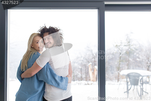 Image of young couple enjoying morning coffee by the window