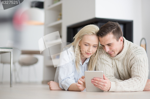 Image of Young Couple using digital tablet on cold winter day