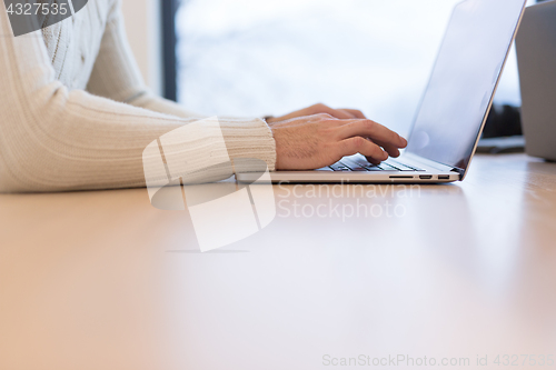 Image of businessman working using a laptop in startup office