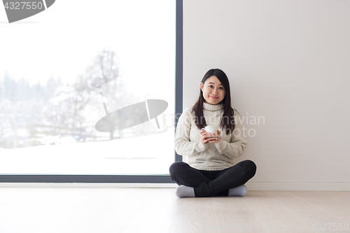 Image of asian woman enjoying morning coffee