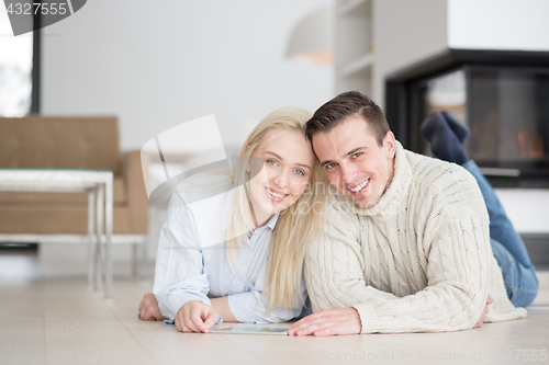 Image of Young Couple using digital tablet on cold winter day