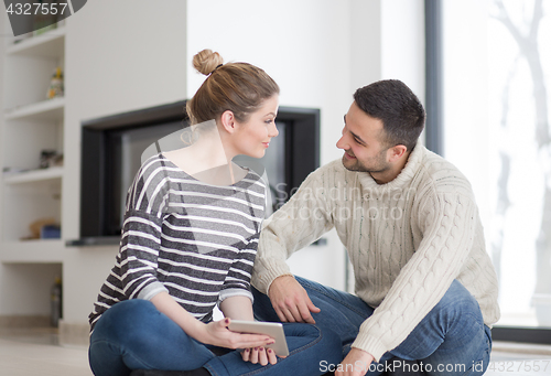 Image of Young Couple using digital tablet on cold winter day