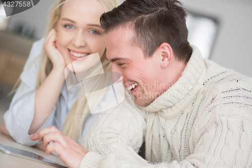 Image of Young Couple using digital tablet on cold winter day