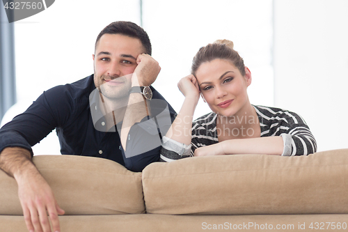 Image of Portrait of young couple sitting on sofa