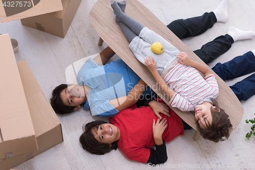 Image of boys with cardboard boxes around them top view