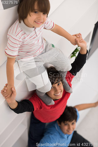 Image of young boys posing line up piggyback top view