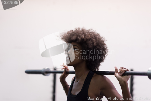 Image of black woman lifting empty bar