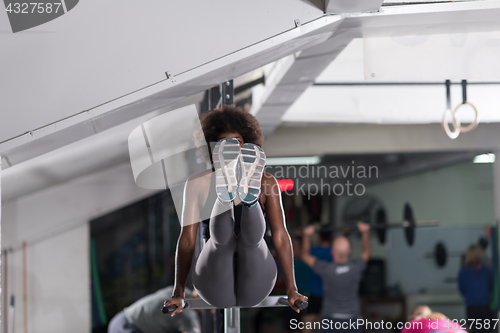 Image of black woman doing parallel bars Exercise