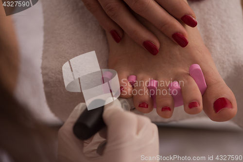 Image of female feet and hands at spa salon