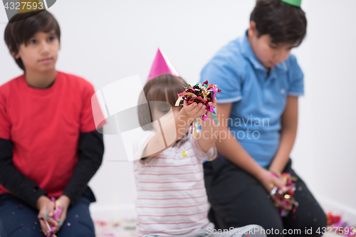 Image of kids  blowing confetti