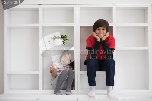 Image of young boys posing on a shelf