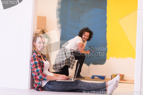 Image of Happy couple doing home renovations