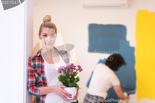 Image of happy young couple doing home renovations