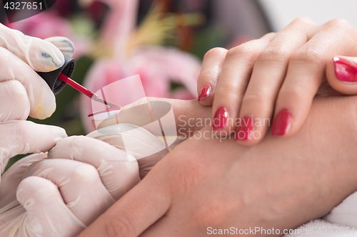 Image of Woman hands receiving a manicure