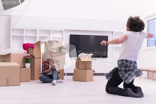 Image of young couple moving  in new house