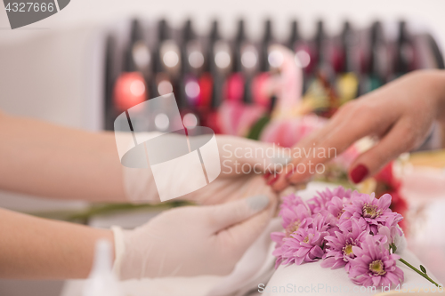 Image of Woman hands receiving a manicure