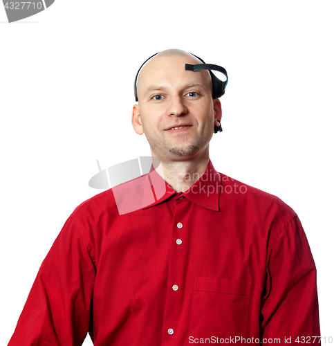 Image of Portrait of young man in red shirt with EEG headset on head