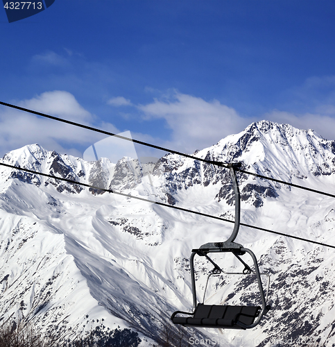 Image of Chair-lift in snow winter mountains at nice sun day