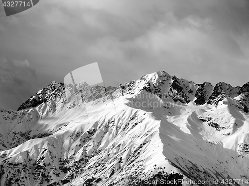 Image of Black and white view on snow sunlight mountain and cloudy sky at