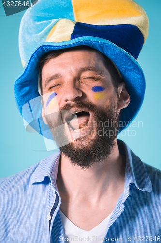 Image of The football fan over blue