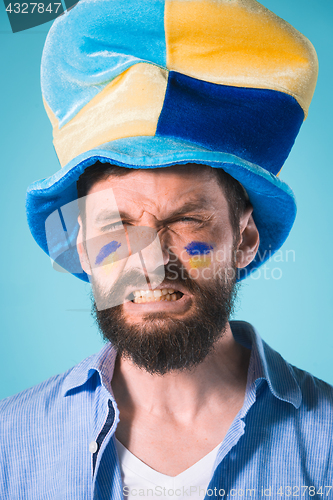 Image of The football fan over blue