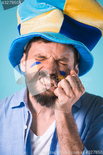 Image of The football fan over blue