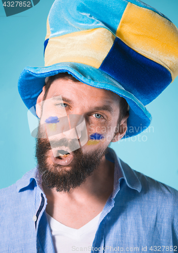 Image of The football fan over blue