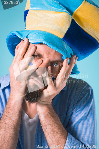 Image of The football fan over blue