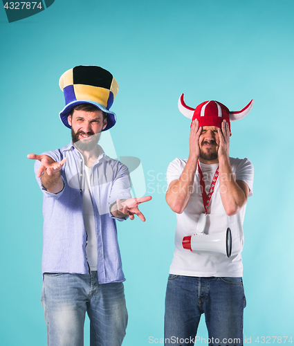 Image of The two football fans over blue