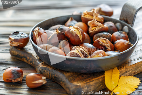 Image of Roast chestnuts in a pan closeup.