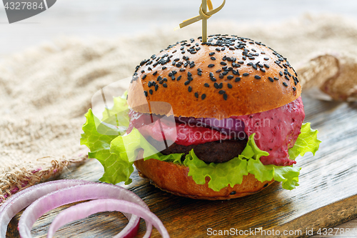 Image of Homemade burger with beef meat and berry sauce.