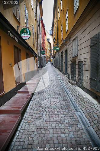 Image of STOCKHOLM, SWEDEN - AUGUST 20, 2016: View of narrow street and c