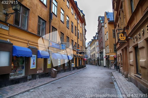 Image of STOCKHOLM, SWEDEN - AUGUST 20, 2016: View of narrow street and c