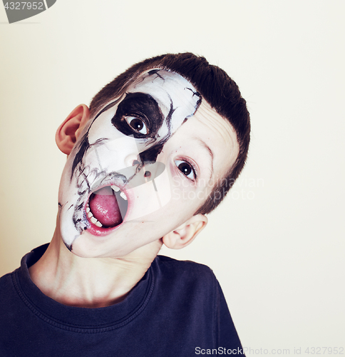 Image of little cute boy with facepaint like skeleton to celebrate hallow