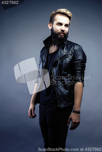 Image of portrait of young bearded hipster guy on gray dark background close up, brutal modern man, lifestyle people concept 