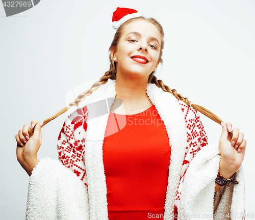 Image of young pretty happy smiling blond woman on christmas in santas red hat and holiday decorated plaid, lifestyle people concept