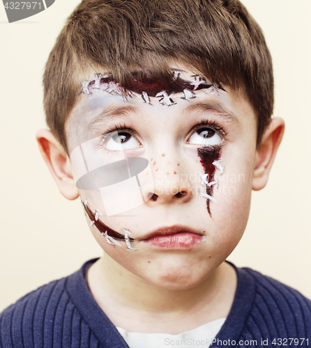 Image of little cute boy with facepaint like zombie apocalypse at hallowe