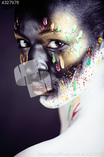 Image of woman with creative makeup closeup like drops of colors, facepai