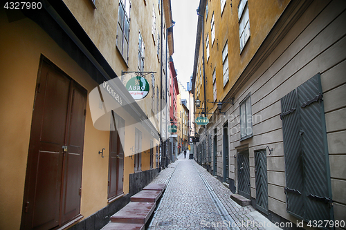 Image of STOCKHOLM, SWEDEN - AUGUST 20, 2016: View of narrow street and c