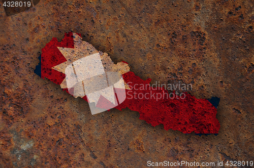 Image of Map and flag of Nepal on rusty metal