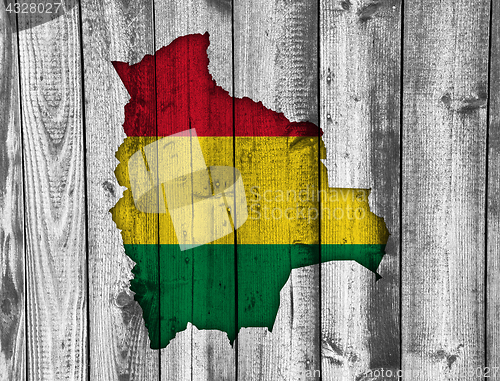 Image of Map and flag of Bolivia on weathered wood