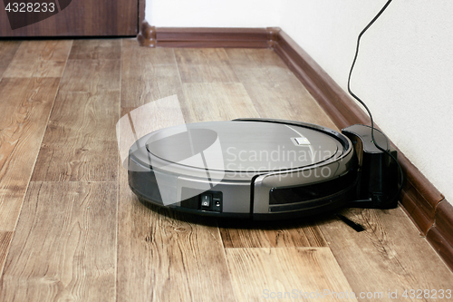 Image of robot vacuum cleaner on the parquet floor