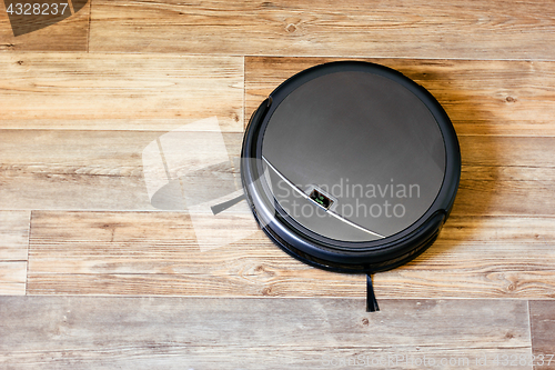 Image of robot vacuum cleaner on the parquet floor