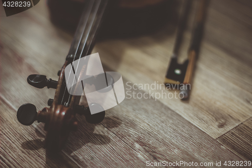 Image of Old violin lying on a wooden surface