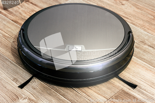 Image of robot vacuum cleaner on the parquet floor