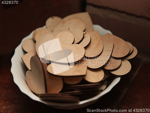 Image of Carved wooden hearts on a white plate.