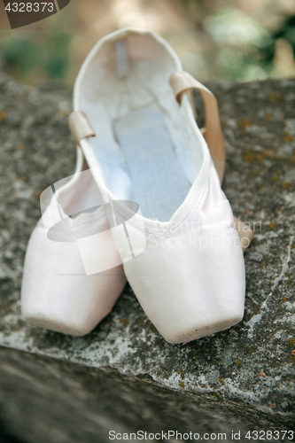 Image of Pointe shoes for a classical ballerina, close-up on concrete